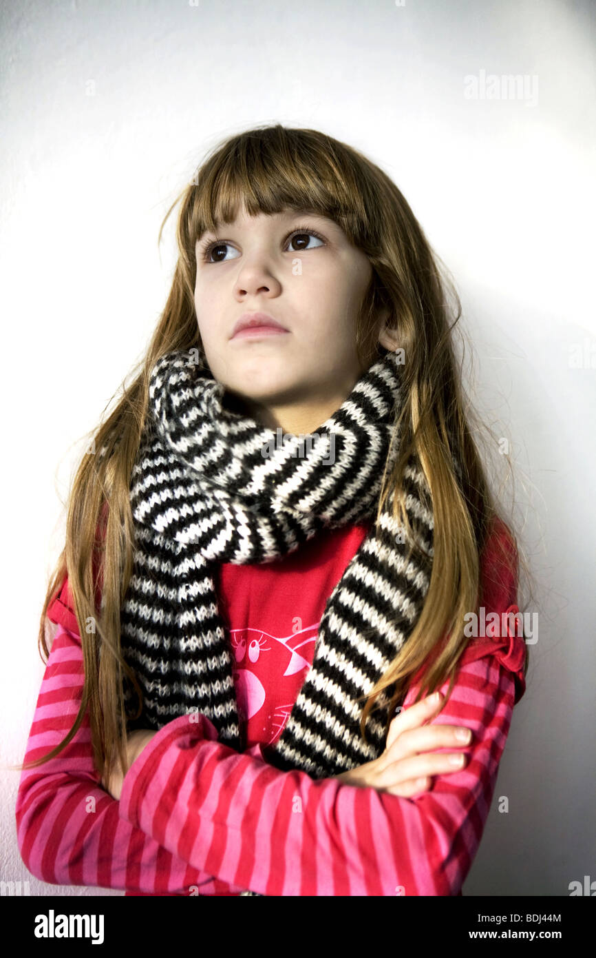 portrait young little serious cute girl with sore throat wearing red t