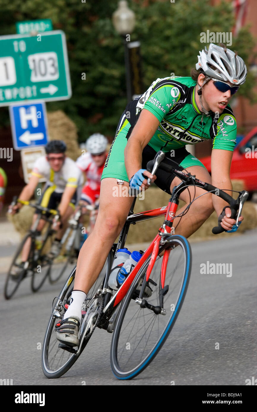 Bikers race through city streets in bike race Stock Photo