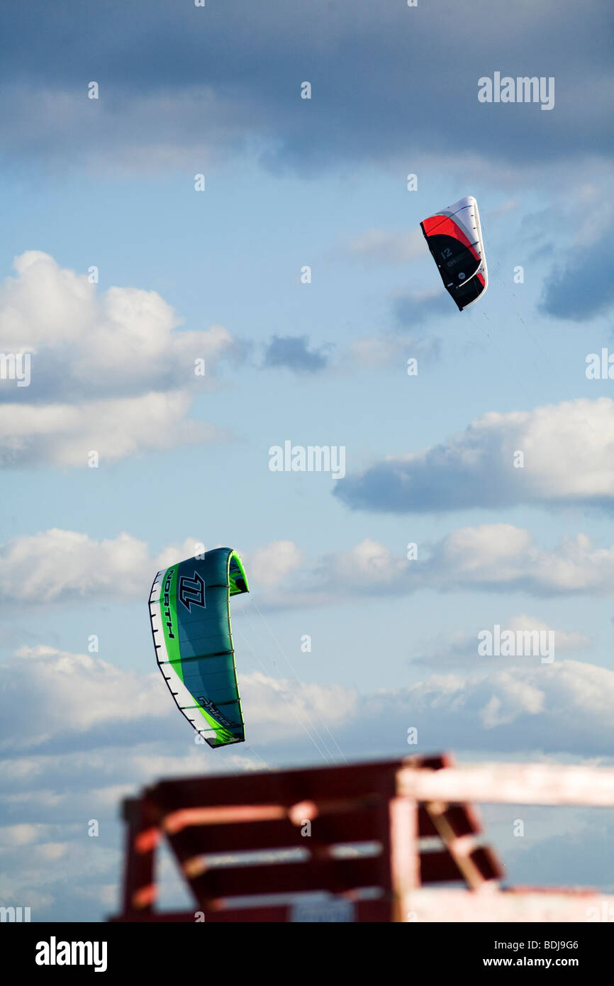 Two kites fly by a lifeguard tower on the beach in Newport Rhode Island