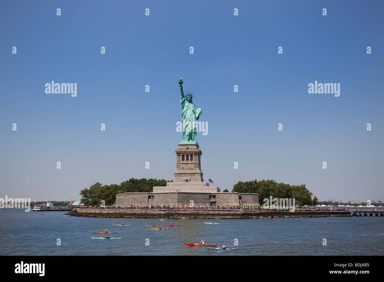 Statue of Liberty witnesses a kayak racing along the Hudson river, New York City, USA. Stock Photo