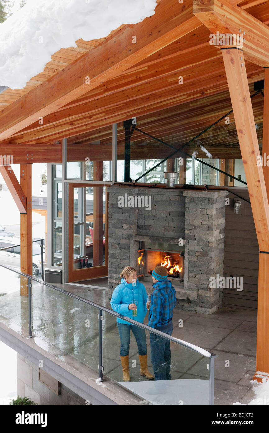 Man and Woman Standing on Chalet Balcony, Whistler, British Columbia, Canada Stock Photo