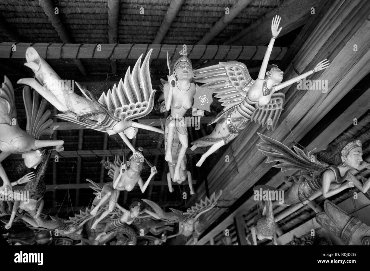 Indonesia, Bali, crafts, Ubud, carved wooden deities hanging from roof
