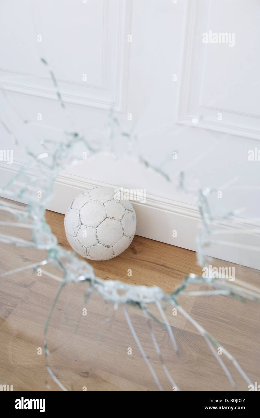 Soccer Ball and Broken Window Stock Photo