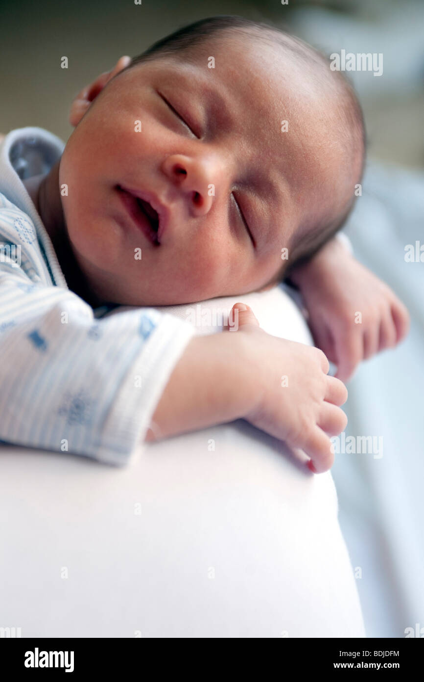 Baby Sleeping on Parent's Shoulder Stock Photo