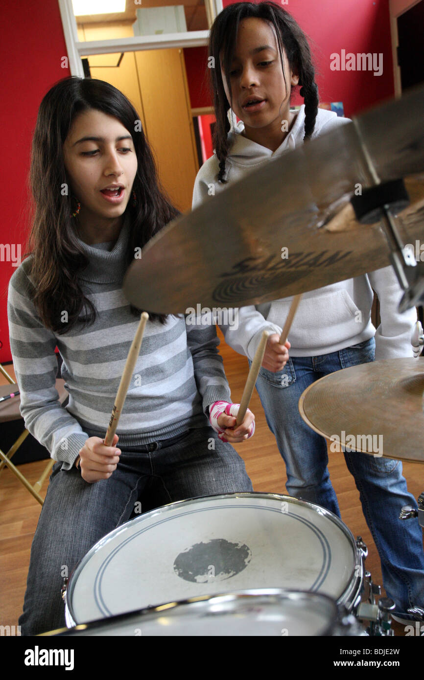 Girls learning to play the drums in a music centre Stock Photo Alamy
