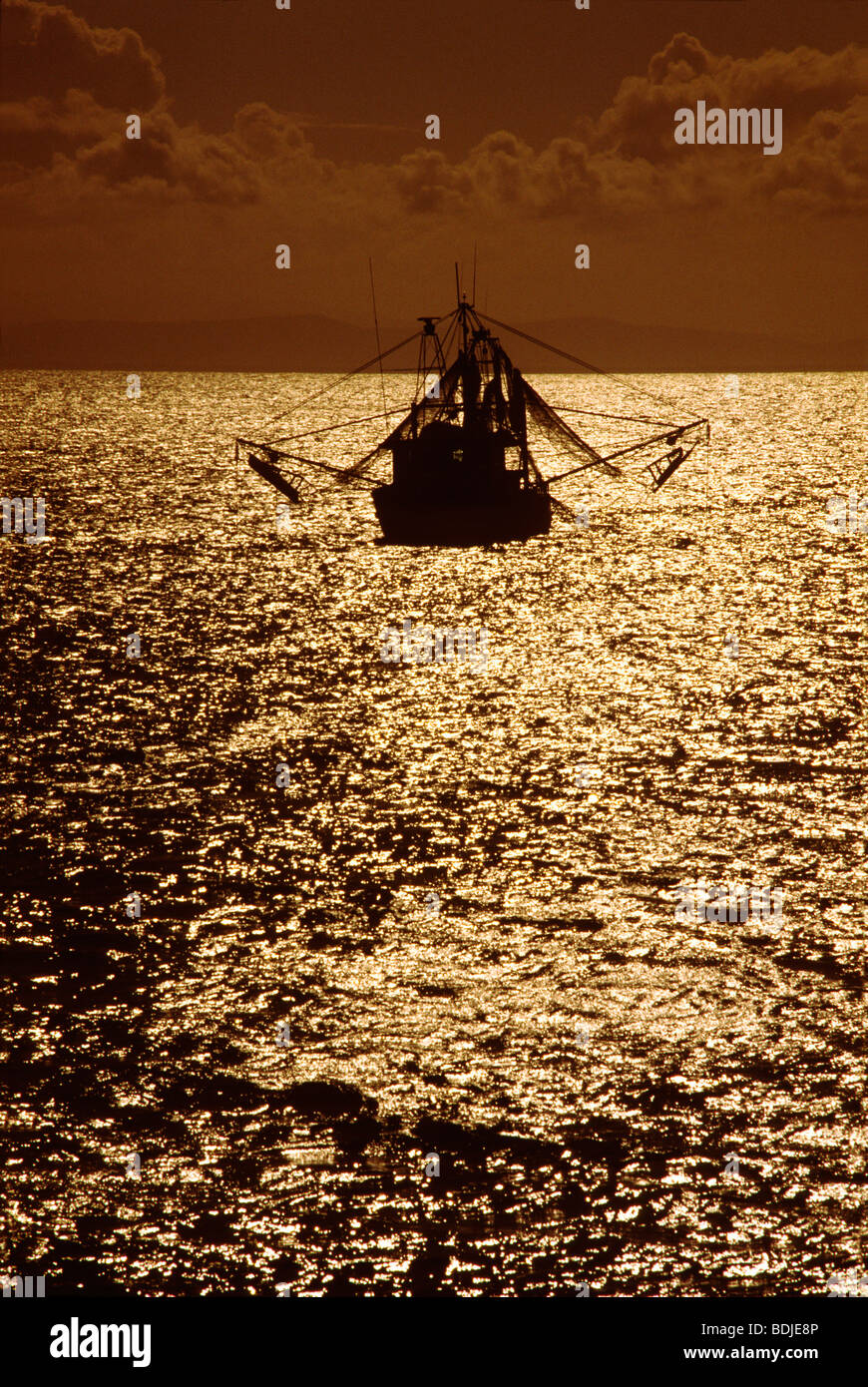 Fishing Boat at Sea, Sunset Silhouette Stock Photo - Alamy