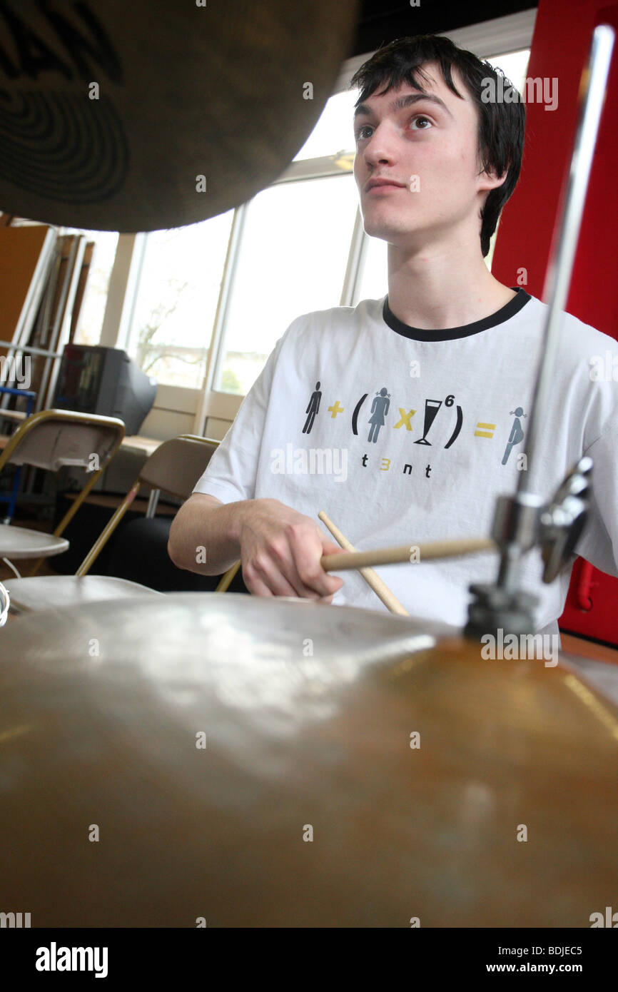 Teenage boy plays the drums in a music centre Stock Photo