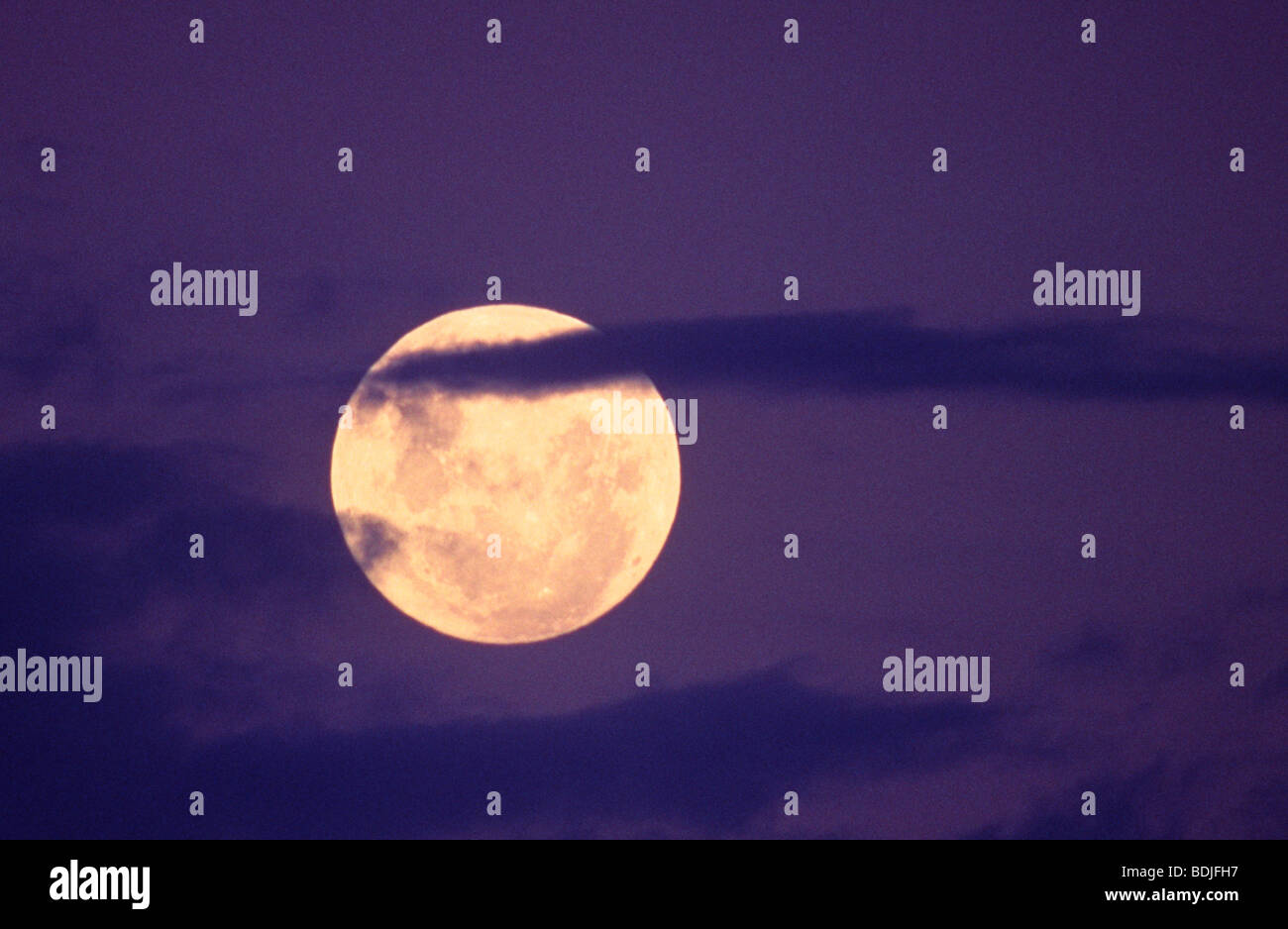 Full Moon behind Clouds Stock Photo Alamy