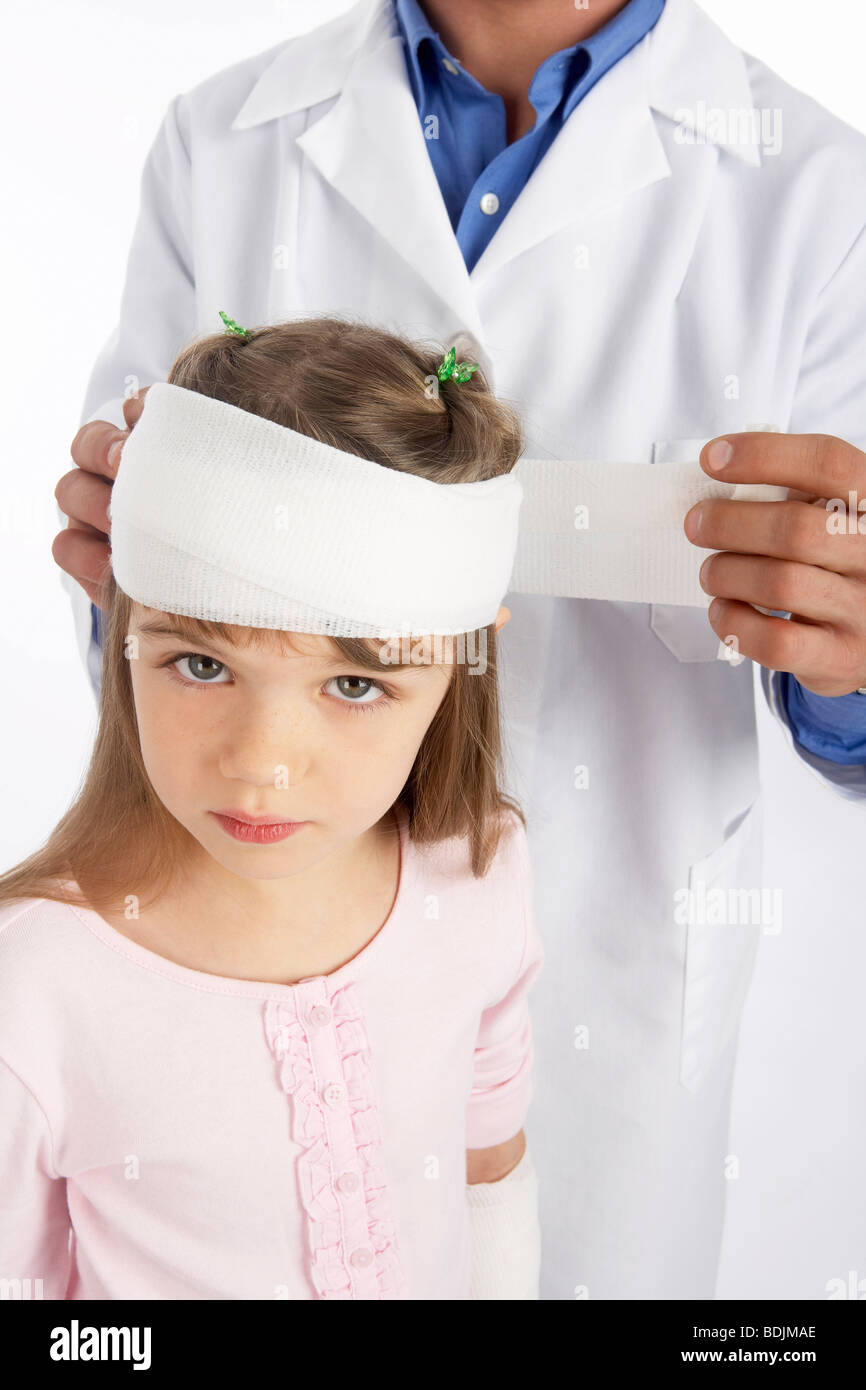 Doctor Wrapping Bandage Around Girl's Head Stock Photo Alamy
