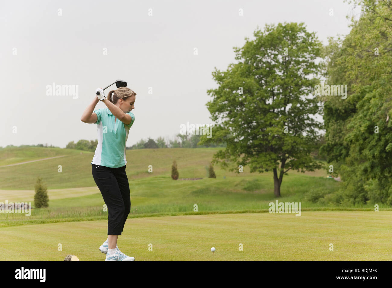 Woman Playing Golf Stock Photo