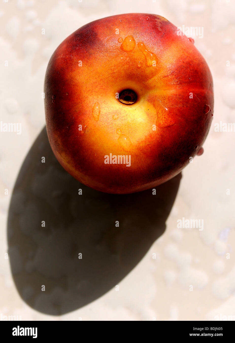 Nectarine fruit ripening in the sun on a windowsill fruit summer Stock