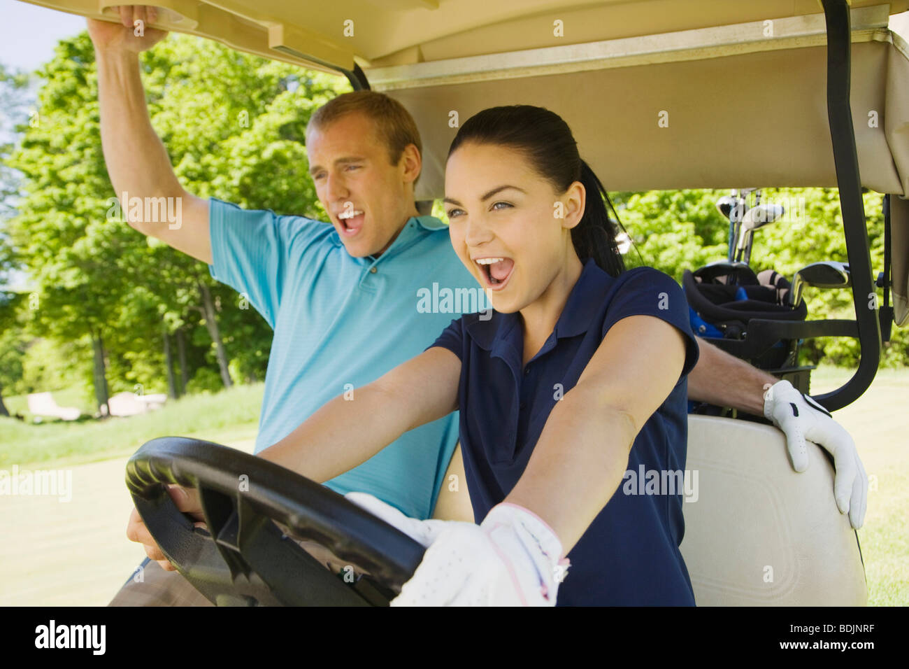 Couple in Golf Cart Stock Photo