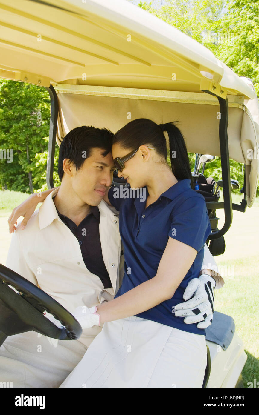 Couple in Golf Cart Stock Photo