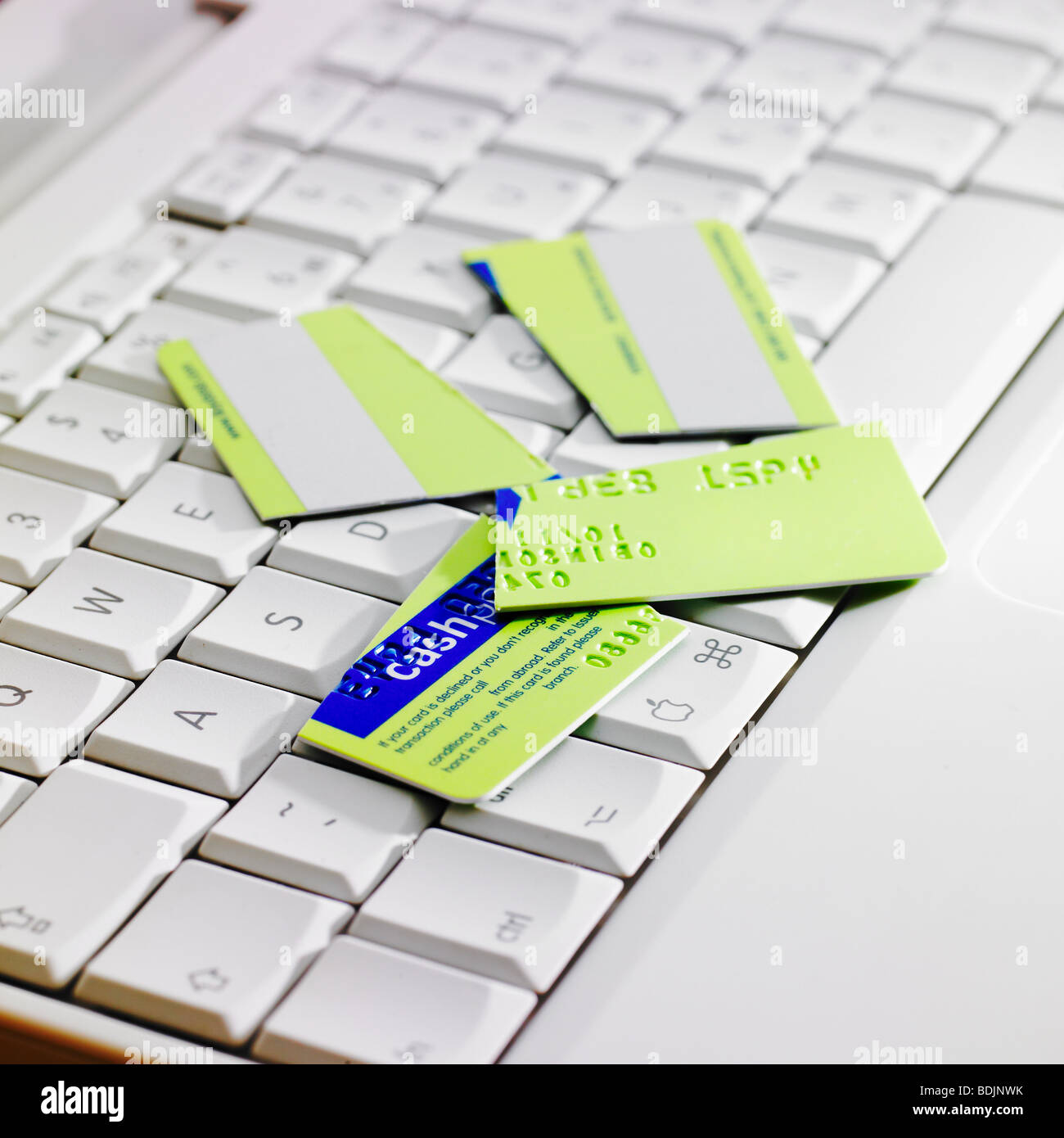 Cut up credit card on laptop keyboard Stock Photo Alamy