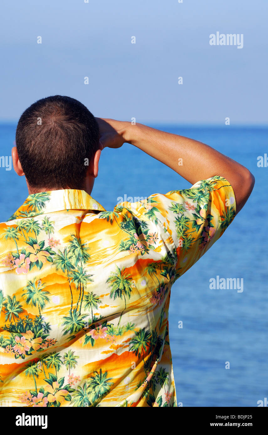 Man looking out to sea wearing Hawaiian shirt Stock Photo - Alamy
