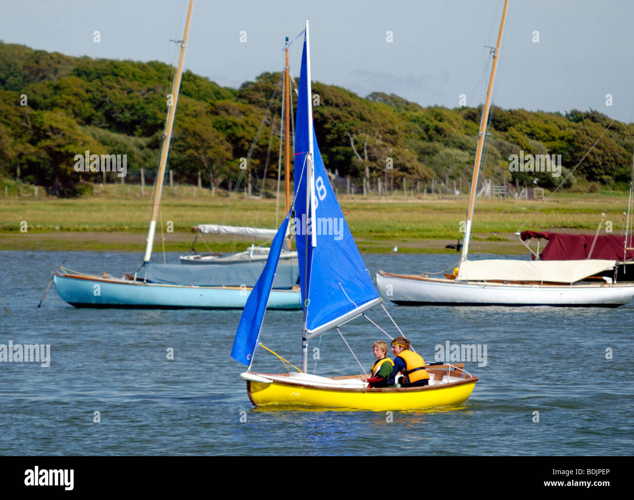 Two children sailing in a dingy Stock Photo