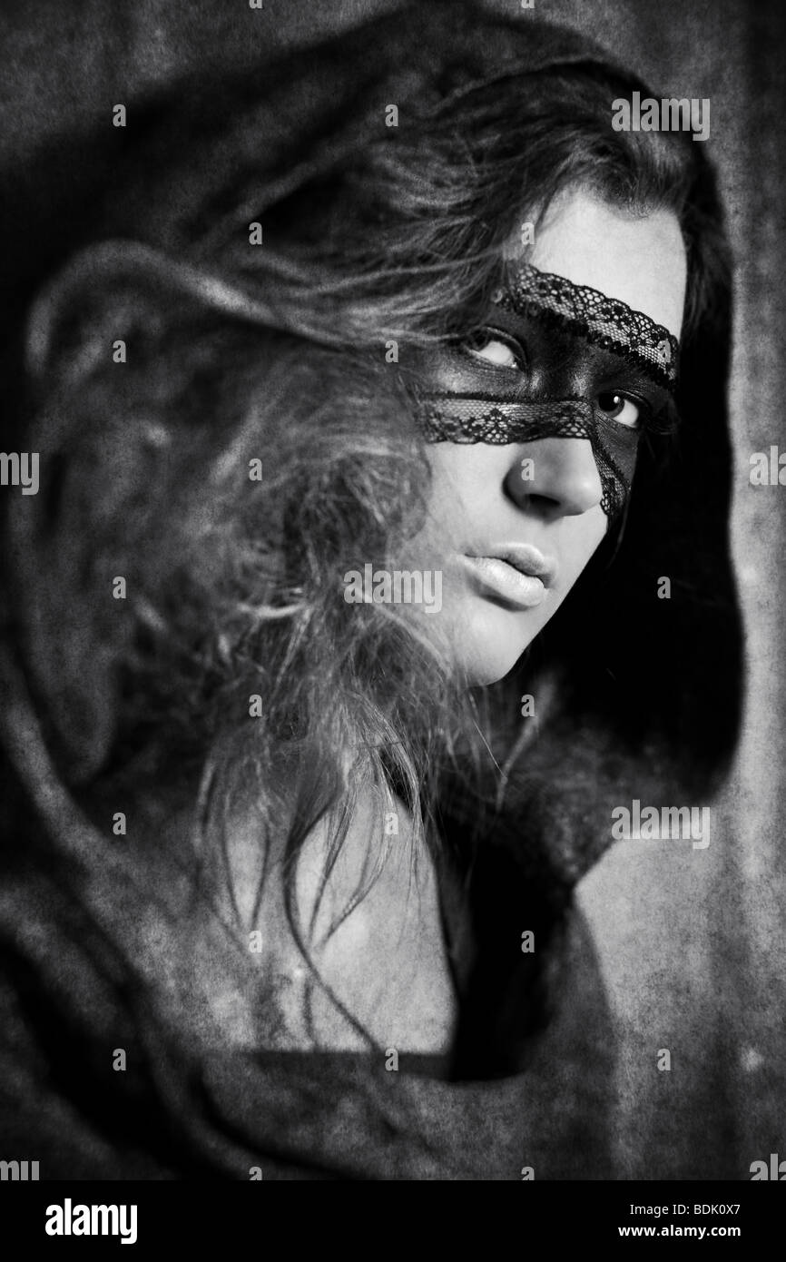 Young woman with mask. Black and white concept with aged effect. Stock Photo