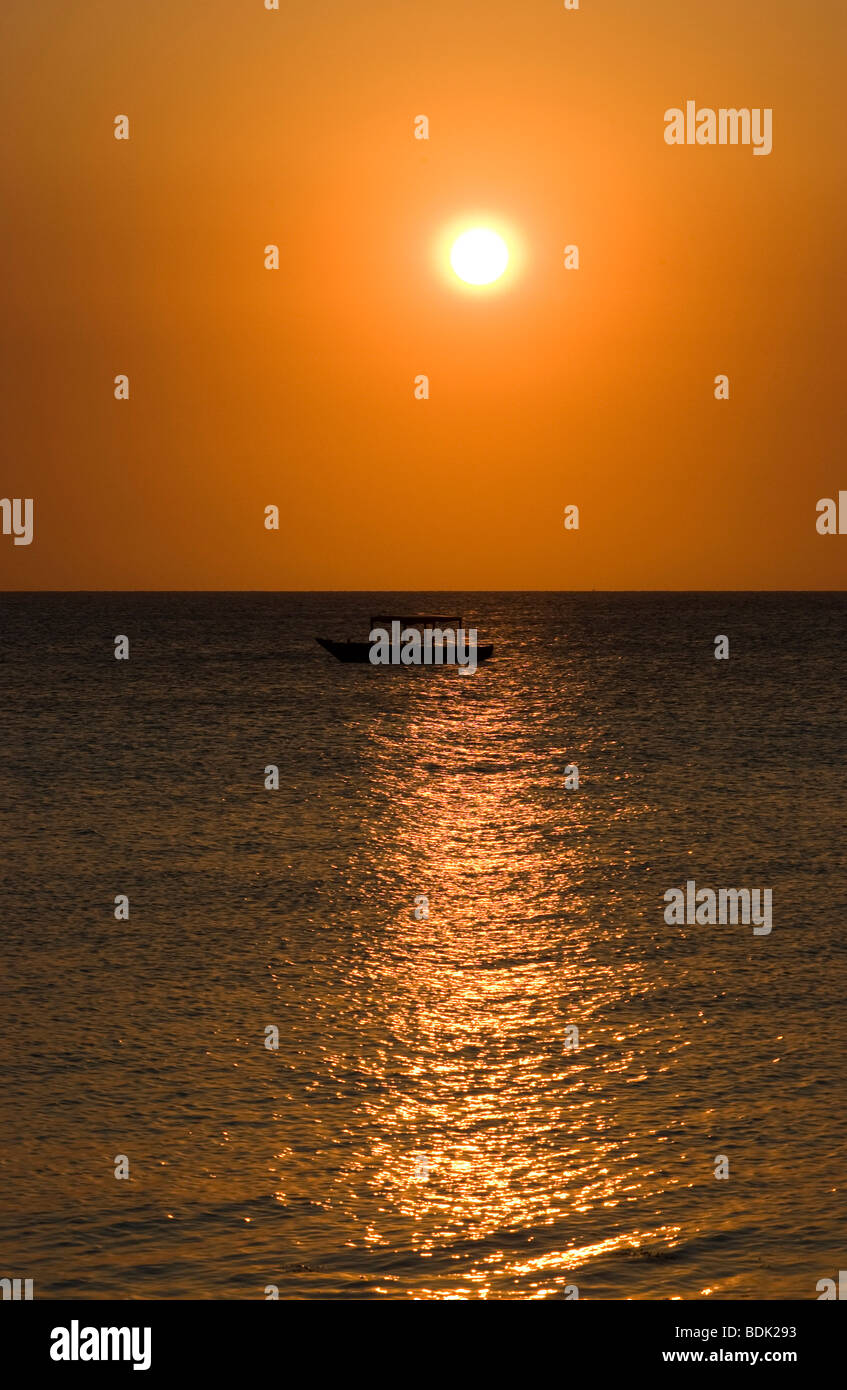 Fishing boat at sunset Stock Photo - Alamy