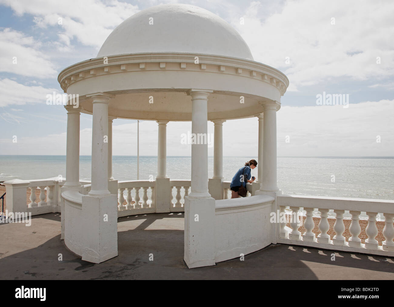 girl looking out to sea under Bexhill pavilion dome Stock Photo