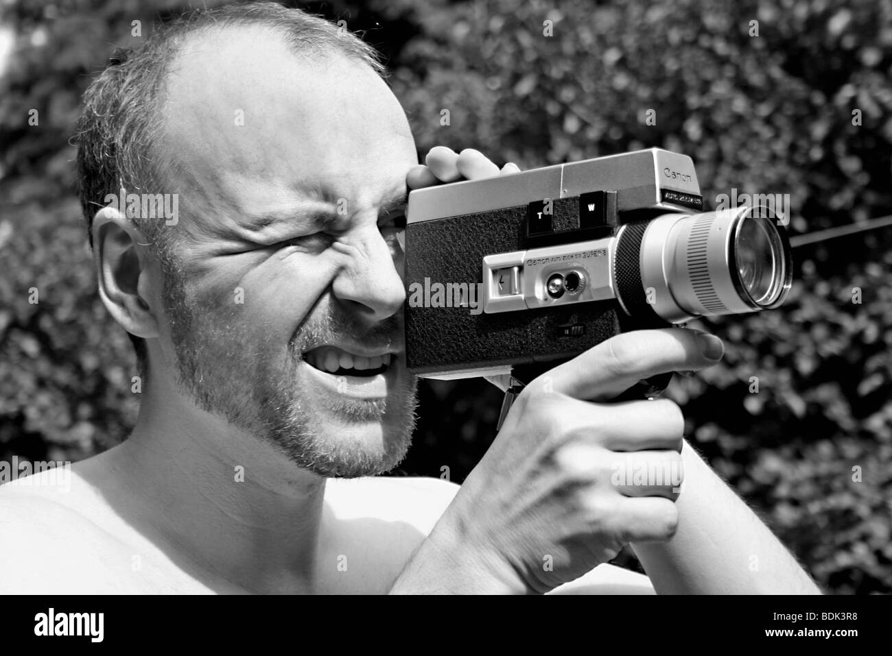 a man playing and film with super 8 camera in london Stock Photo - Alamy
