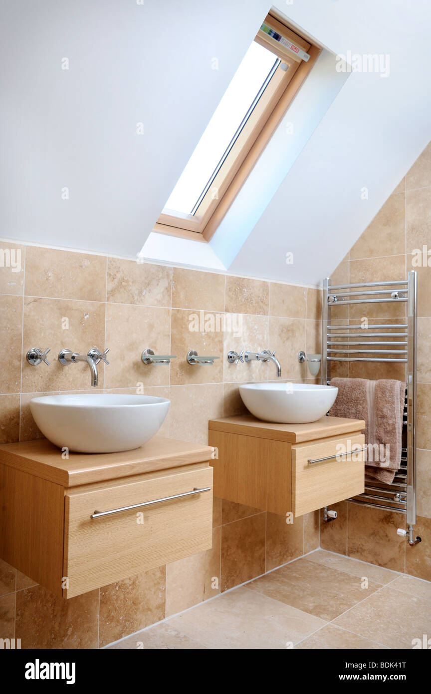 A MODERN BATHROOM WITH TWIN SINKS AND VELUX ROOF WINDOW Stock Photo