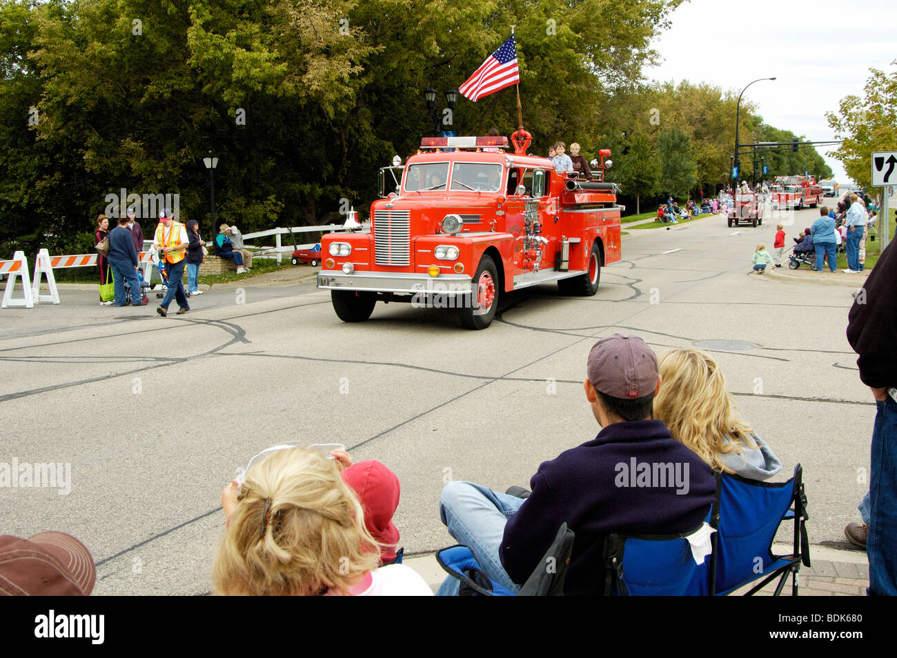 Fire and rescue vehicles being driven in a fire muster parade Stock