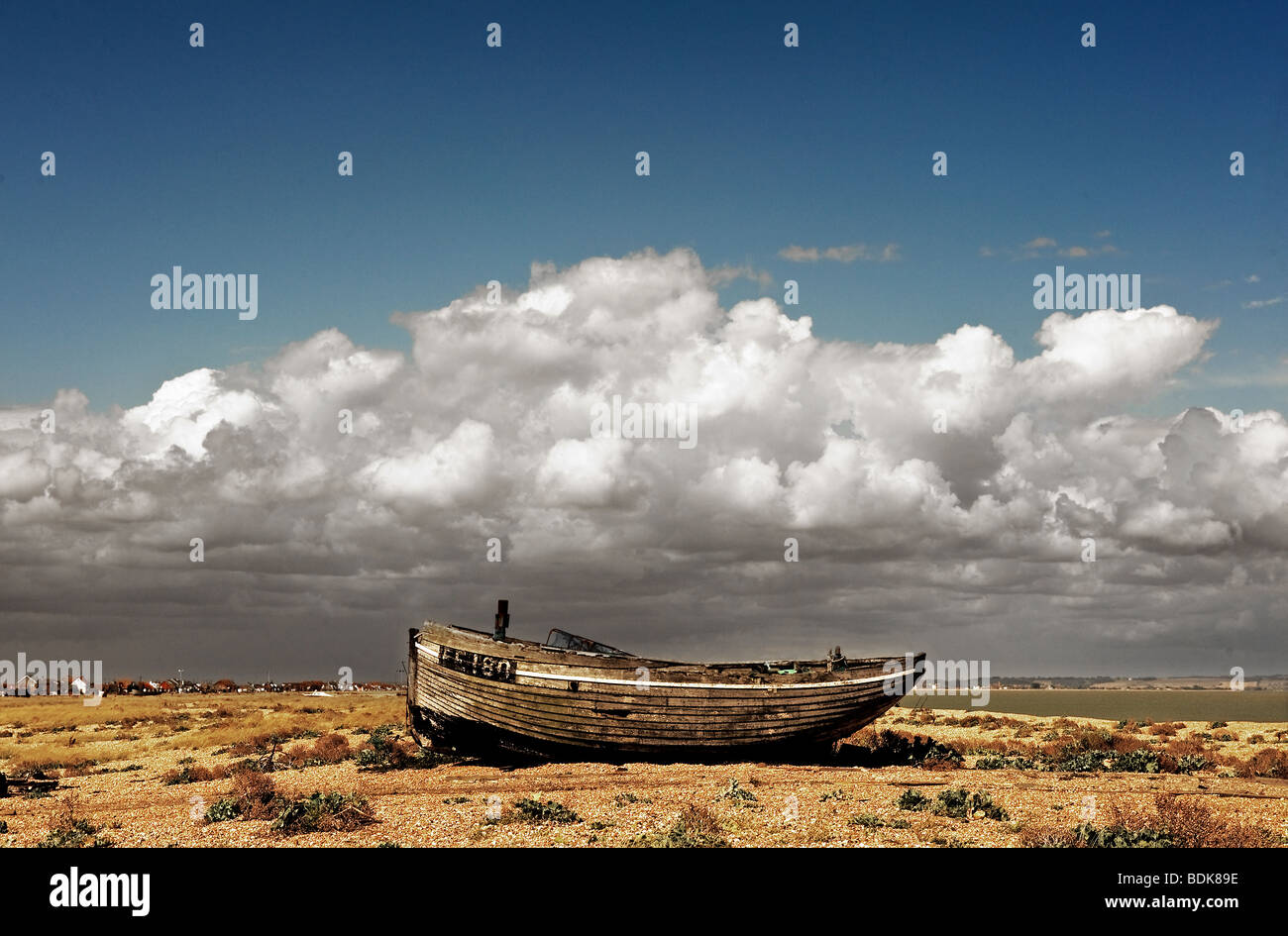 An abandoned wooden fishing boat on the shingle at Dungeness in Kent ...