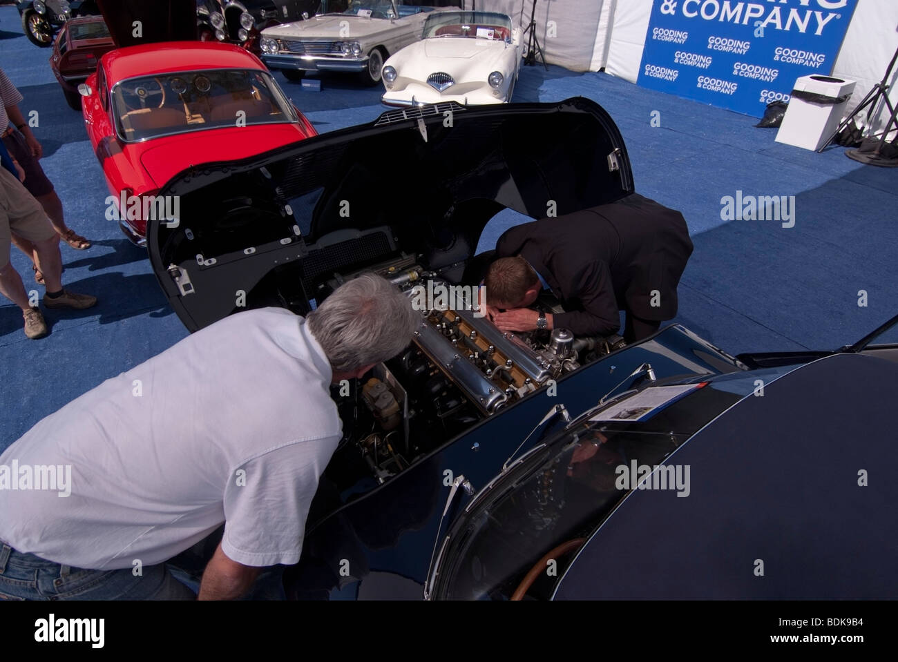 Inspecting a 1965 Jaguar E-Type Series I 4.2 Litre Roadster, Gooding & Company tent at 2009 Pebble Beach Concours d'Elegance Stock Photo
