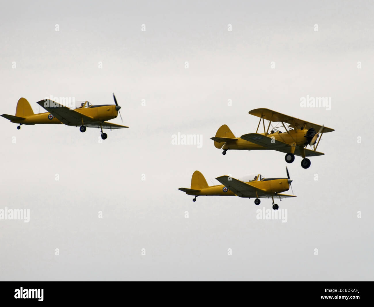 Flying chipmunks vintage planes are flying in formation  in an overcast sky. Stock Photo