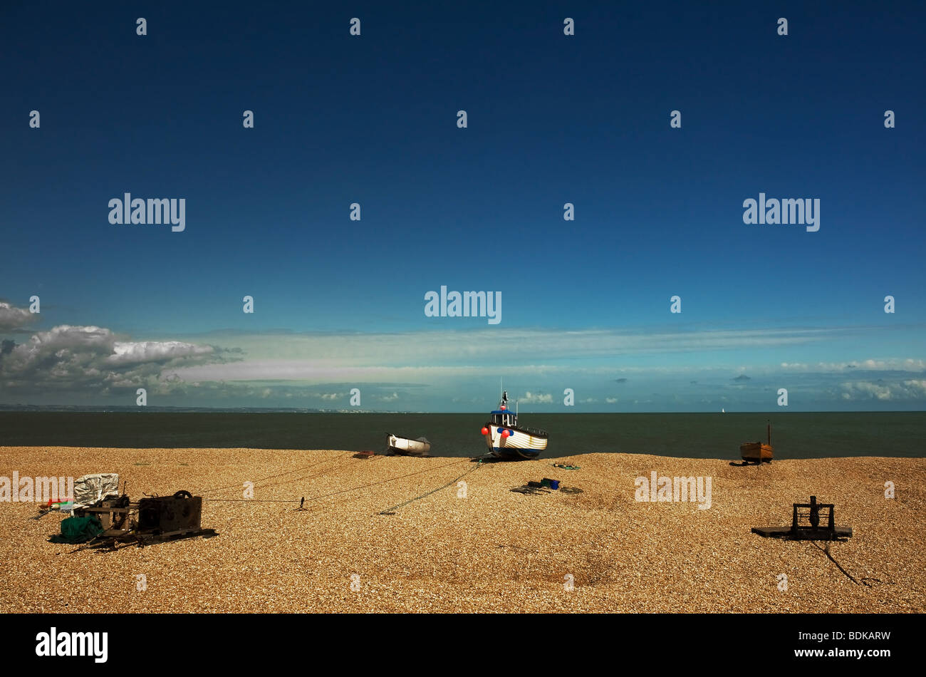 A fishing boats and winching gear on the shingle beach at Dungeness in Kent. Stock Photo