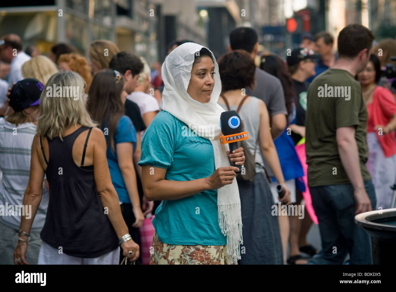 Female Middle Eastern television reporter does here stand-up report in New York Stock Photo