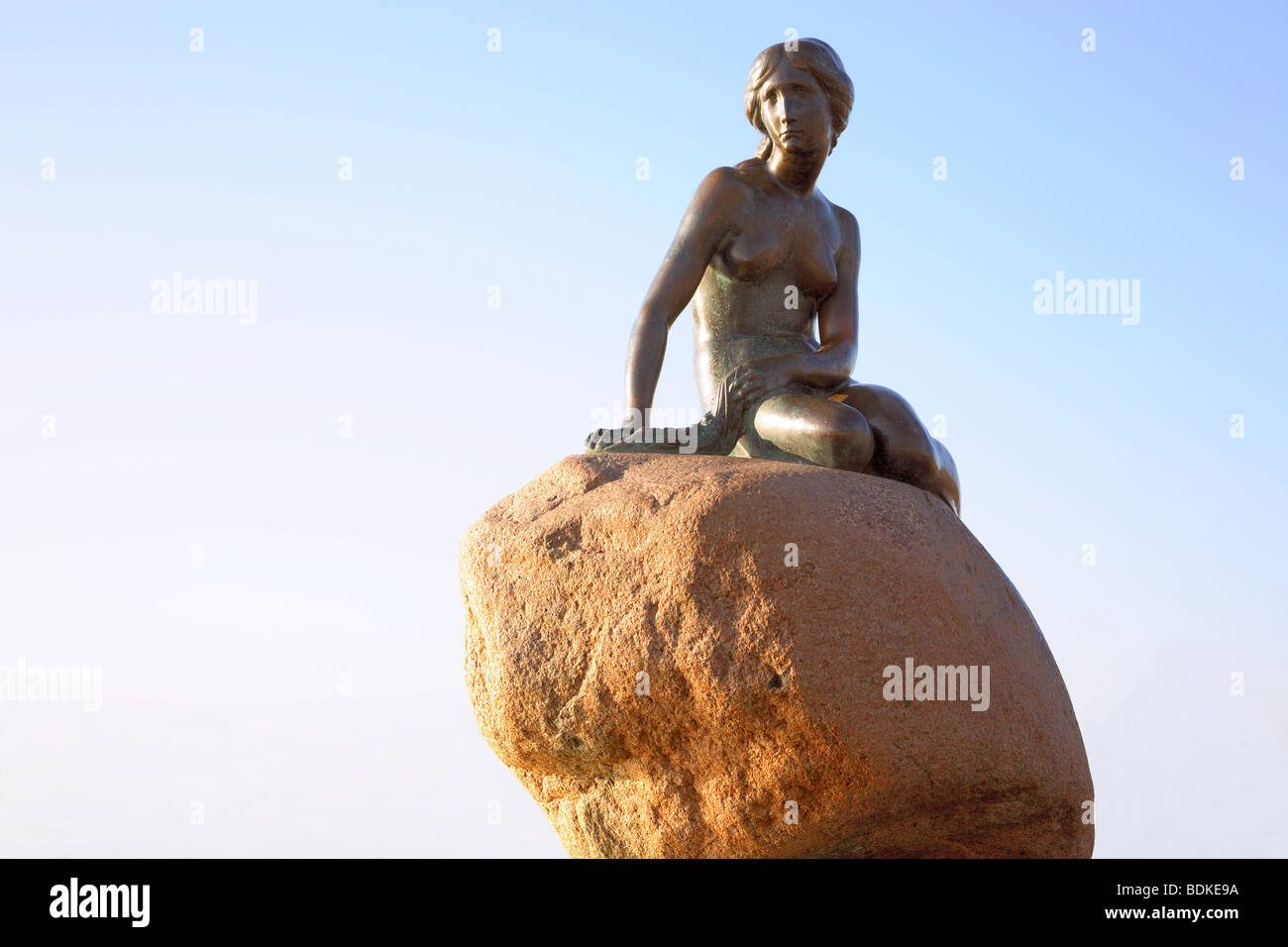 The Little Mermaid at the waterfront at Langelinie in the harbour of Copenhagen, Denmark. Stock Photo