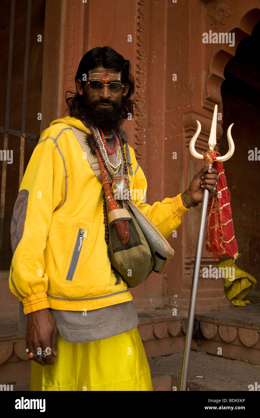 A Sadhu holds a trident in the Indian city of Varanasi (Benares). The Sadhu is a Shiva devotee and a pujari (priest) Stock Photo