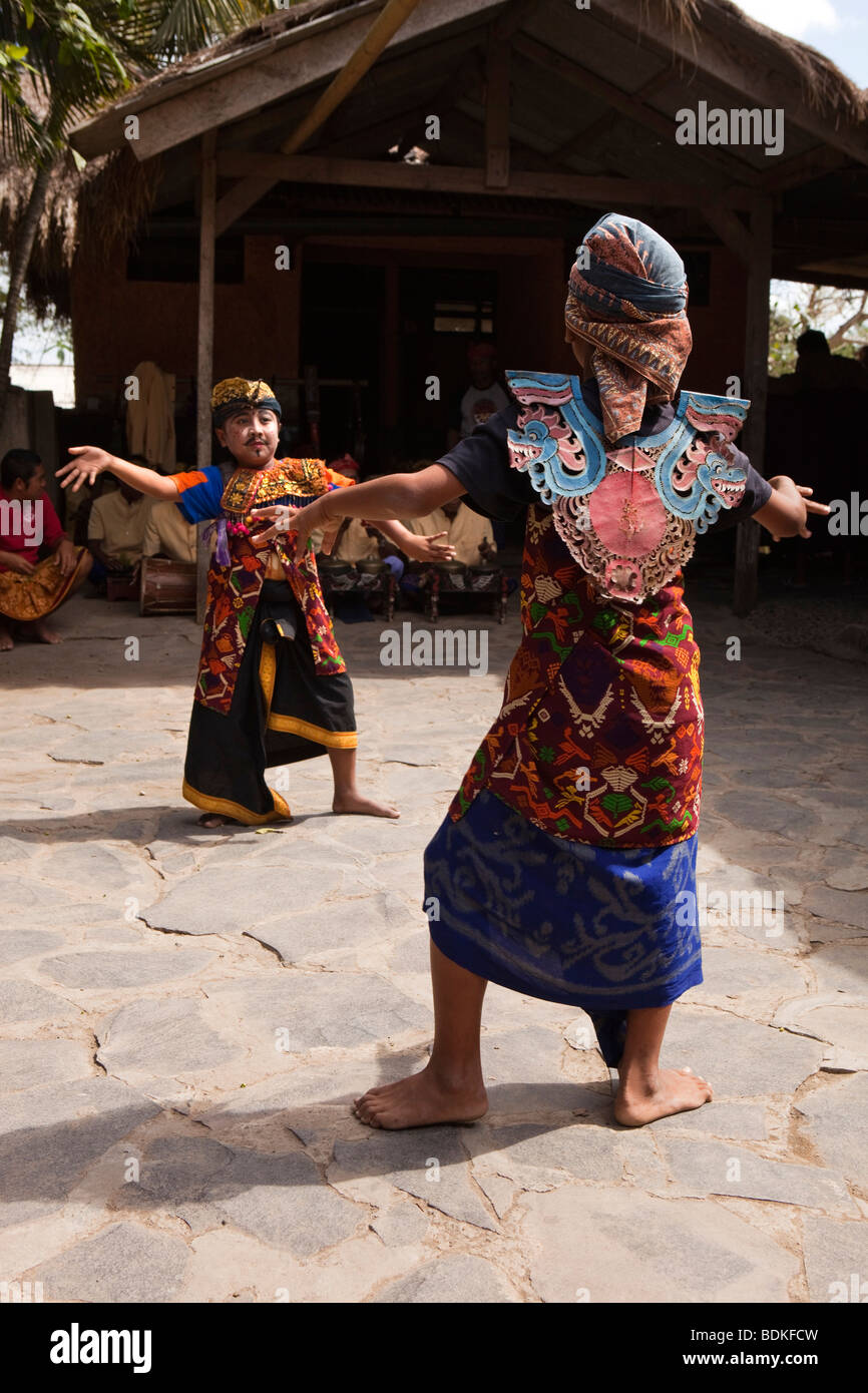 Indonesia, Lombok, Sade, traditional Sasak village, two boys dancing to welcome visiting party of tourists Stock Photo