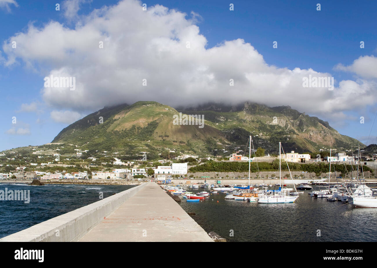 Mt Epomeo shrouded in white clouds from Forio harbour wall, Ischia, Italy Stock Photo