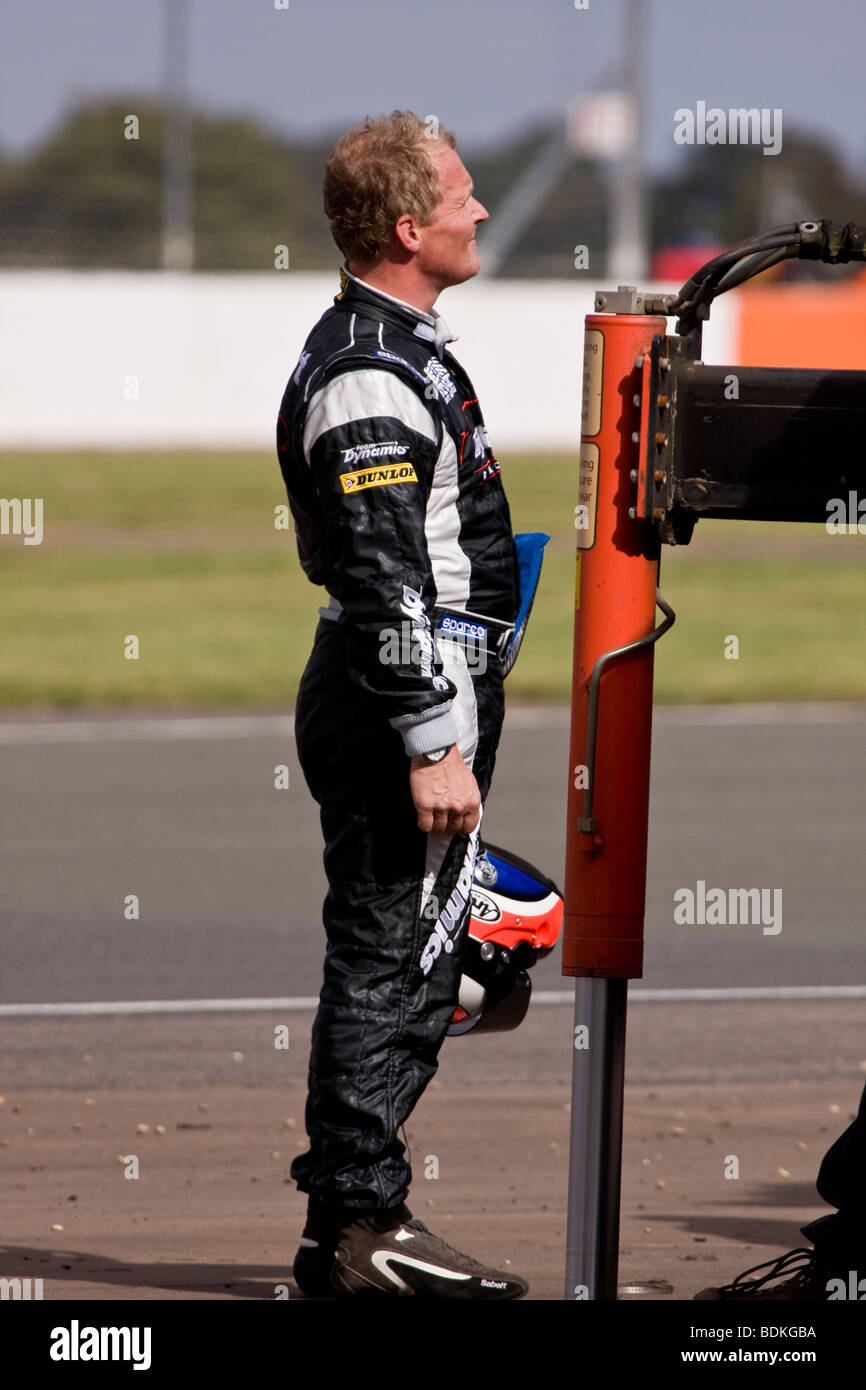 Johnny Herbert looking on as his damaged car is lifted from the circuit. Stock Photo