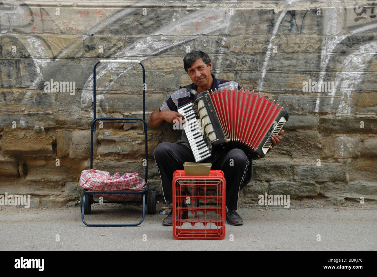 A gypsy street musician playing the accordion in the city of Tuzla, in Bosnia and Herzegovina. Stock Photo