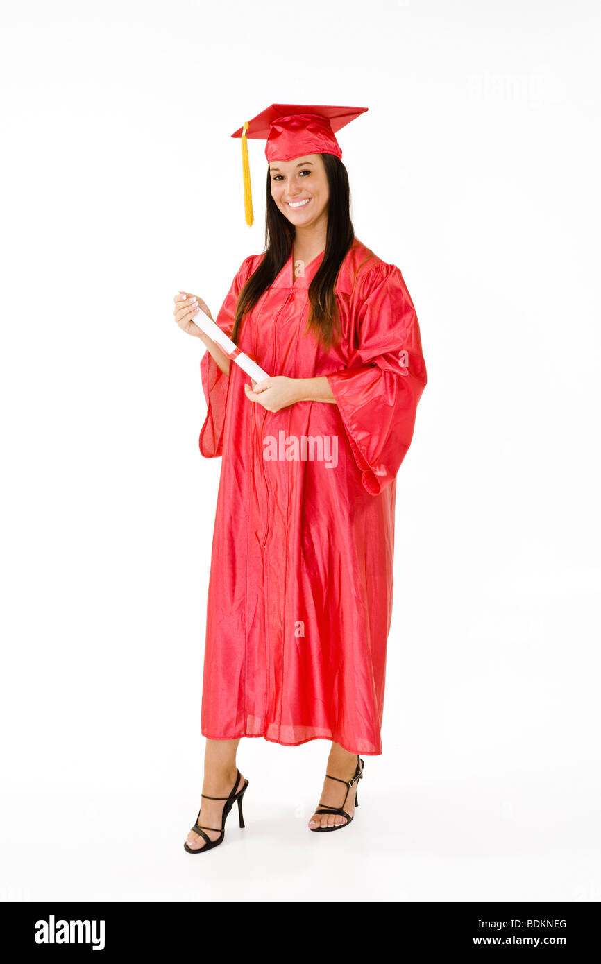 A female Caucasian in red graduation gown and very excited. She is on a white background. Stock Photo