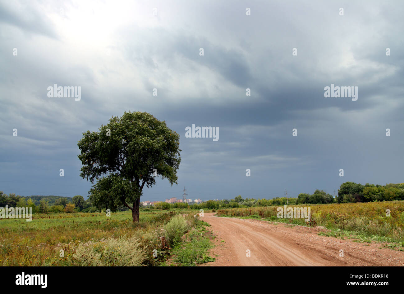 Dirt road under the dark sky hi-res stock photography and images - Alamy