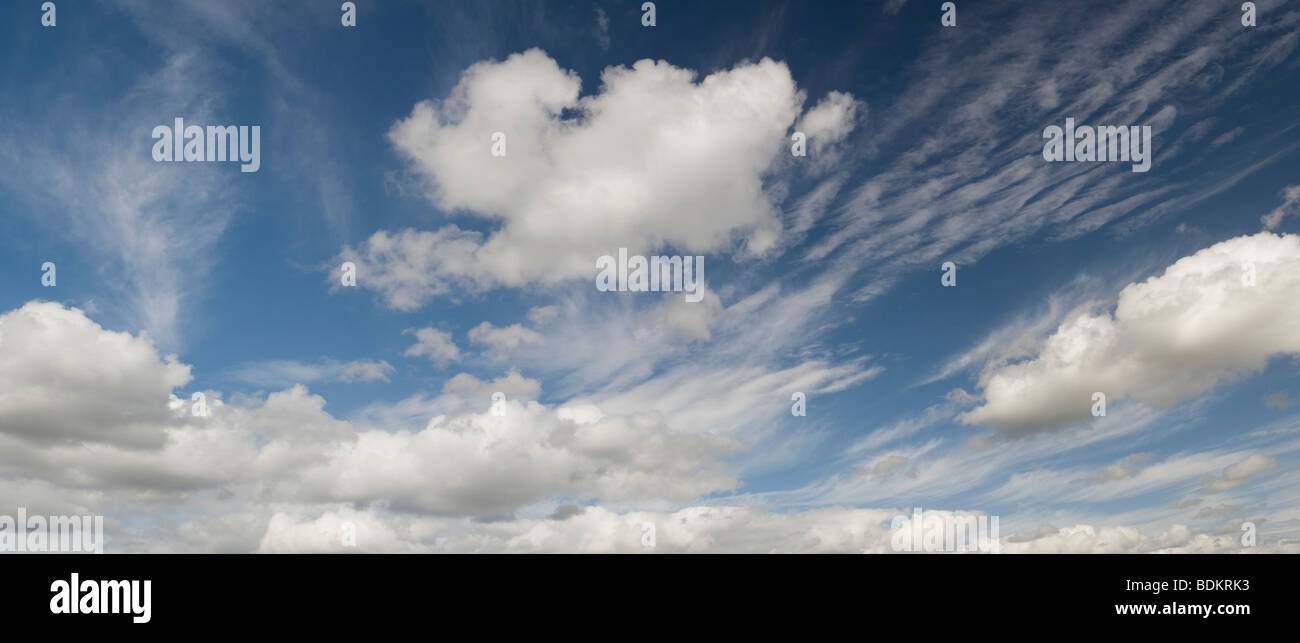 Altocumulus undulatus and cumulus clouds Stock Photo