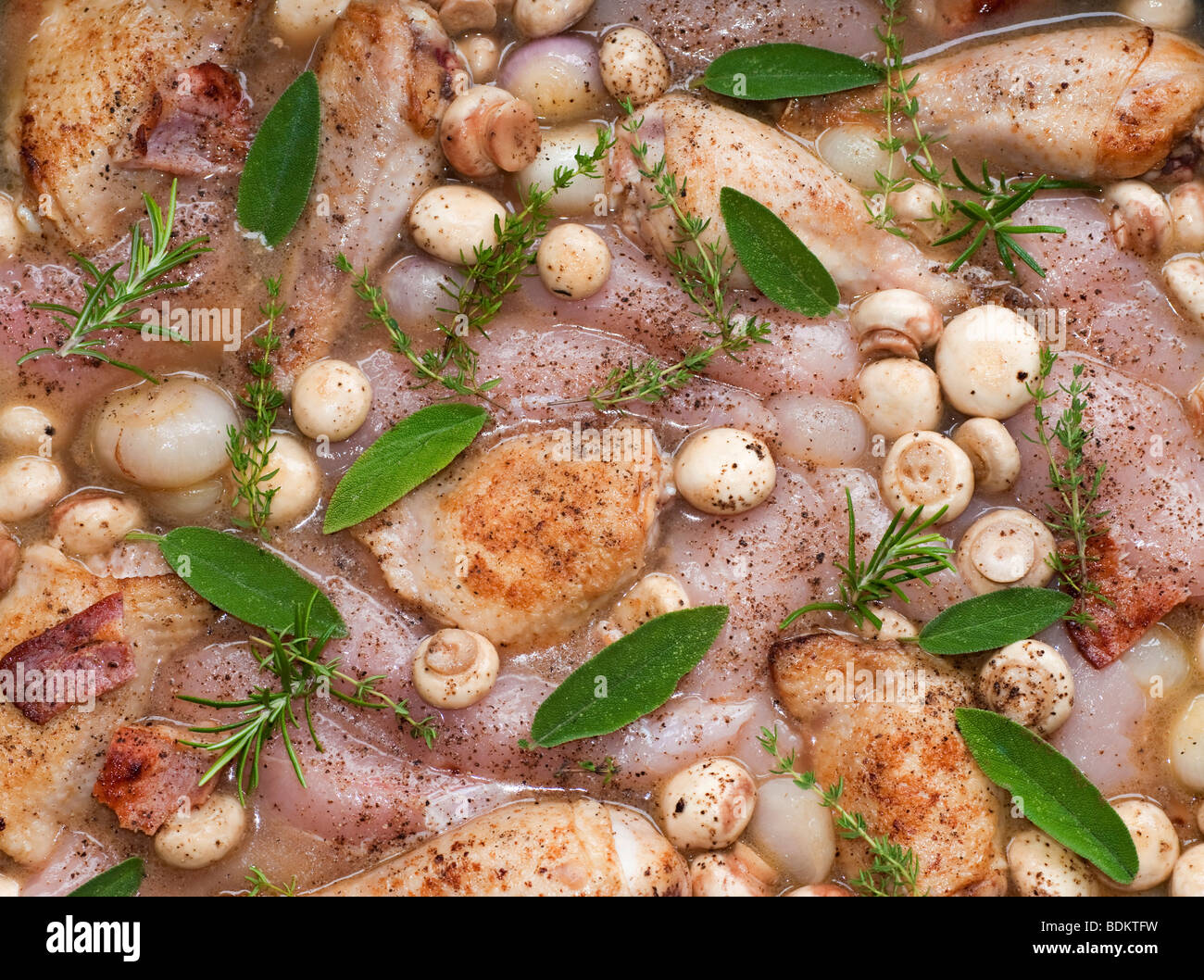 Chicken Casserole dish with herbs and mushrooms ready to be cooked in an oven Stock Photo
