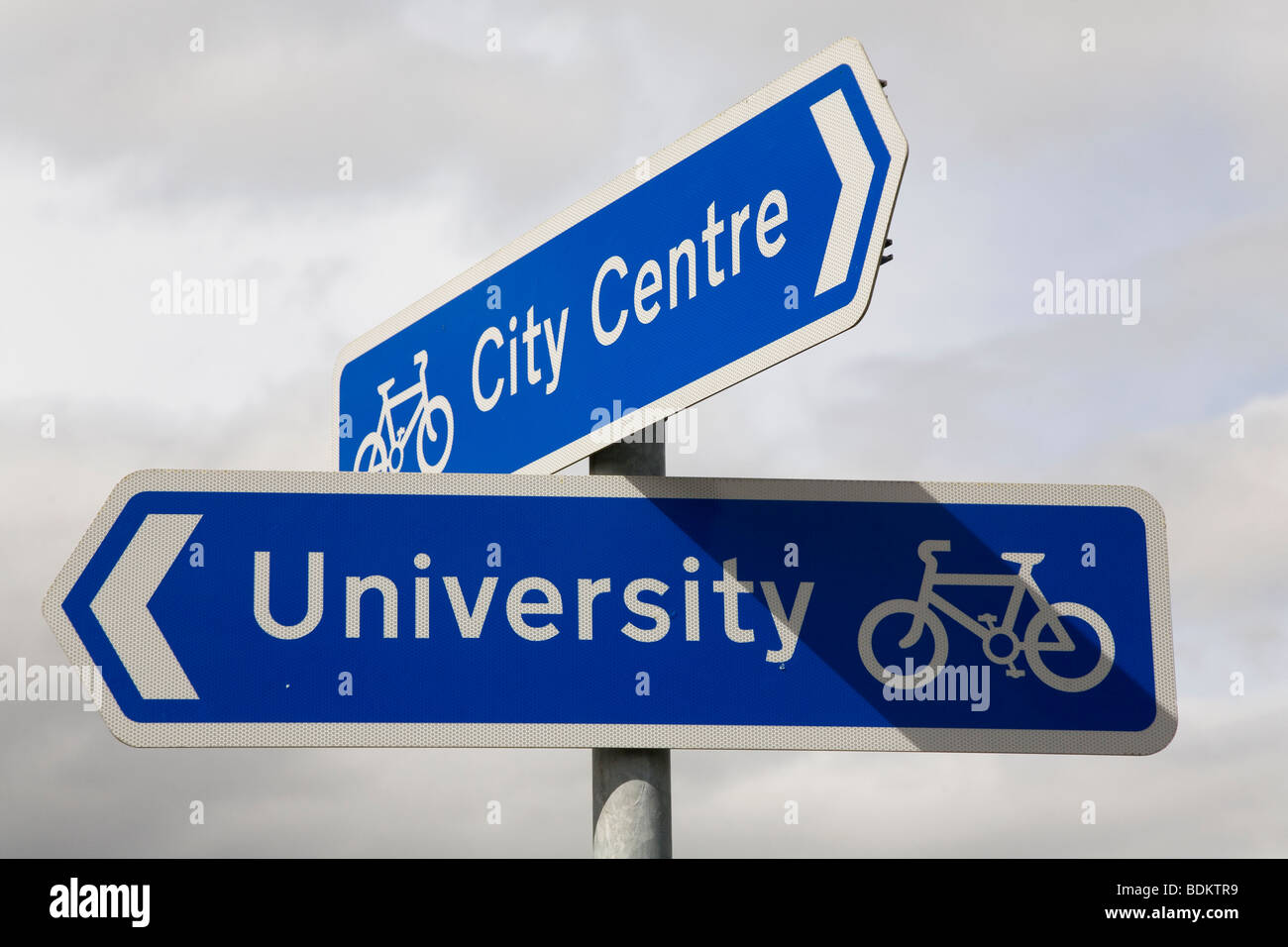 Street signs for cycle paths in the UK. One of the signs points towards the university and the other towards the city centre. Stock Photo
