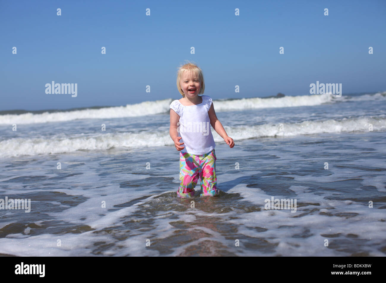Young girl in water at beach Stock Photo
