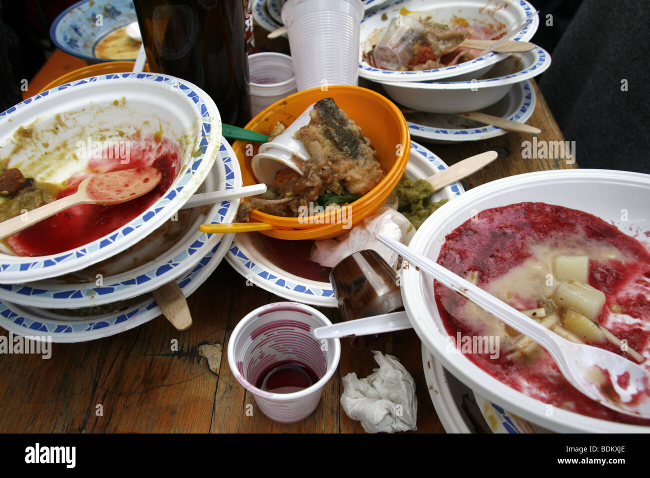 pile of food dishes on wooden table outdoors Stock Photo