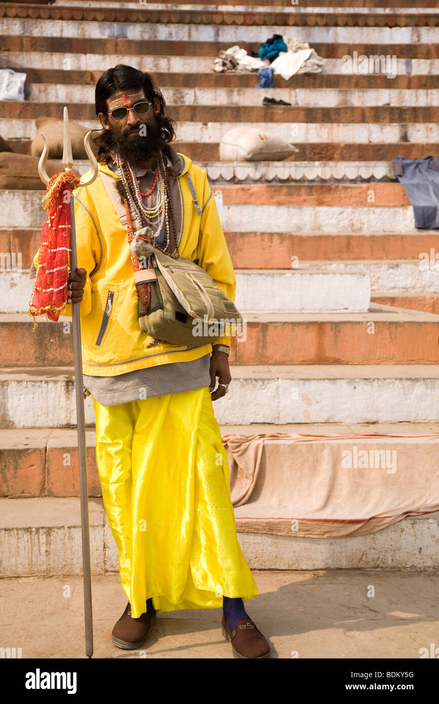 A Sadhu in the Indian city of Varanasi (Benares). The Sadhu, a Shiva devotee and a pujari, holds a trident, Shiva's symbol. Stock Photo