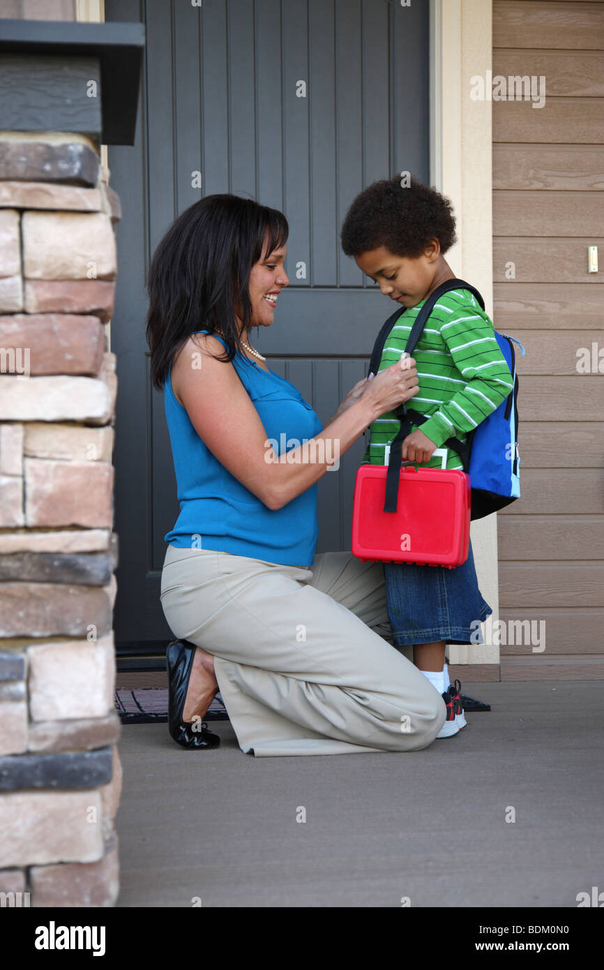 Mother gets child ready for first day of school Stock Photo