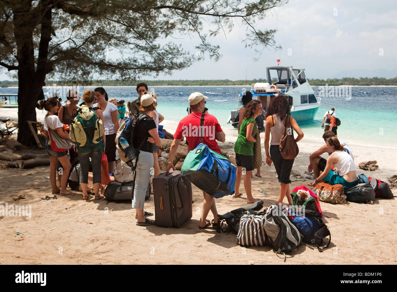 Indonesia, Lombok, Gili Trawangan, backpackers waiting on beach for fast boat to Bali Stock Photo