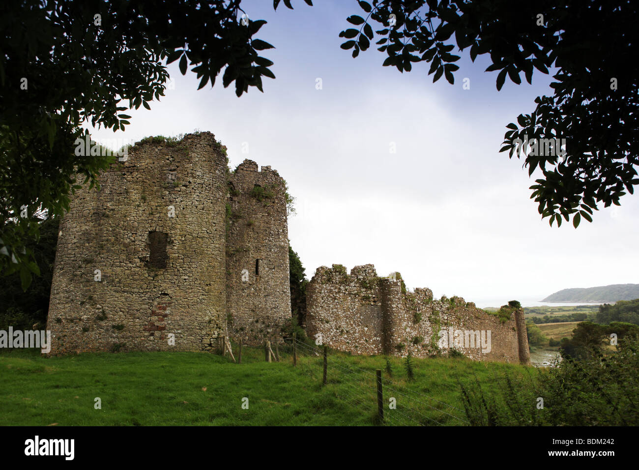 Ruins of Penrice Castle overlooking Oxwich Bay on Gower peninsular near Swansea South Wales UK Stock Photo