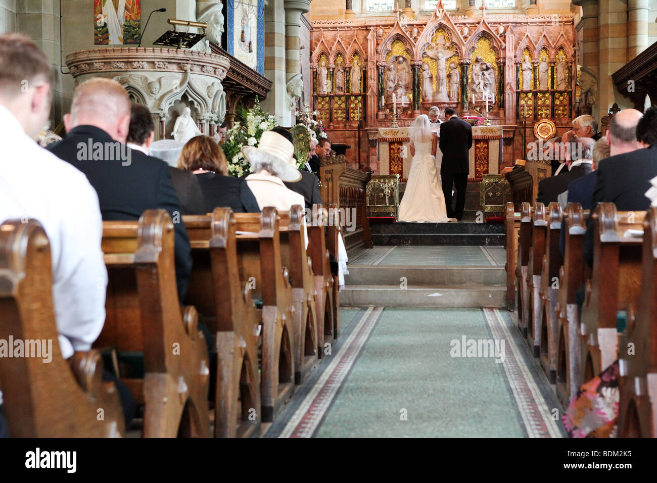 Cathedral like church with bride and groom at altar during traditional religious wedding ceremony in the UK Stock Photo