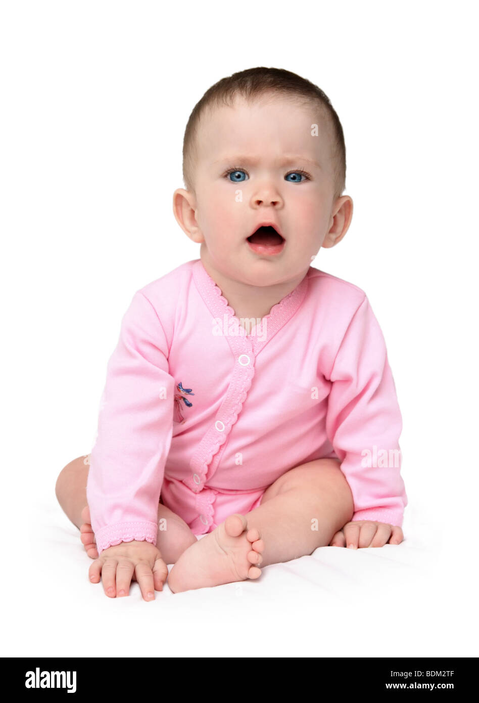 displeased baby girl sitting in white background Stock Photo